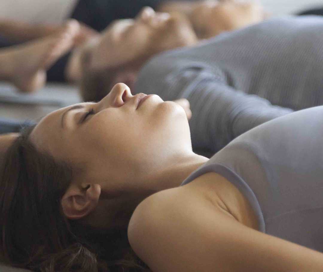 Frau , die häufig an Migräne durch Stress leidet, macht Entspannungsübungen.